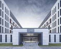 the entrance to an office building that is white and grey