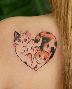 a woman's back shoulder with two cats in the shape of a heart