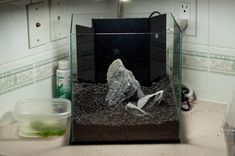 an aquarium with rocks and gravel in it