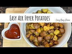 easy air fryer potatoes in a white bowl with ketchup on the side