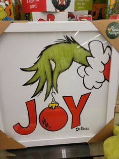 an image of a sign with the word joy painted on it in front of some children's books