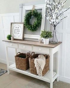 a white table with baskets and flowers on it