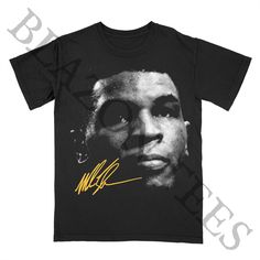 Celebrate the legend of "Iron" Mike Tyson with this rare vintage boxing graphic tee. A perfect addition for boxing enthusiasts and streetwear fans, this tee combines classic sports style with modern fashion. 🥊 * Exclusive Mike Tyson "Iron Mike" graphic tee * Rare vintage boxing streetwear design * Soft, breathable fabric for comfort * Unisex fit available in multiple sizes * Perfect for casual wear, boxing fans, or collectors * Durable print for long-lasting wear Mike Tyson Graphic Tee, Iron Mi Hip Hop Crew Neck T-shirt For Sports Events, Hip Hop T-shirt With Graphic Print For Sports Events, Band Merch Sports T-shirt With Crew Neck, Band Merch Crew Neck T-shirt For Sports, Sports T-shirt With Band Merch Graphic Print, Sports Band Merch T-shirt With Graphic Print, Sporty Graphic Print T-shirt For Boxing, Crew Neck Graphic Print T-shirt For Boxing, Boxing Streetwear