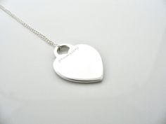 Overview:Offered for sale is a wonderful Tiffany classic. Whether you are just starting your Tiffany collection or are thinking of adding another piece, this one is perfect for you. Tiffany & Co.'s Sterling Silver Heart Tag necklace is a Tiffany classic that will never go out of style. It will most certainly be a piece that you will turn to over and over again, so it is great value for your money! It is a wonderful necklace that fits a lifestyle on the go -- the necklace can be worn to almost an Luxury Silver Heart Necklace Gift, Classic Polished Heart Necklace For Valentine's Day, Classic Polished Heart Necklace For Wedding, Classic Engraved Heart Pendant Necklace, Classic Polished Necklace For Anniversary Gift, Classic Polished Necklace For Anniversary, Classic Necklace With Polished Finish For Anniversary, Classic Engraved Open Heart Necklace, Classic Valentine's Day Heart Pendant Necklace