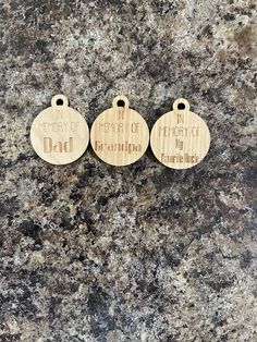 three wooden tags with words on them sitting on a granite surface