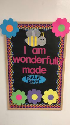 a bulletin board that says i am wonderfully made with flowers and a bee on it