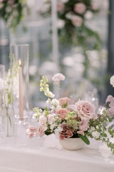 the table is set with flowers and candles