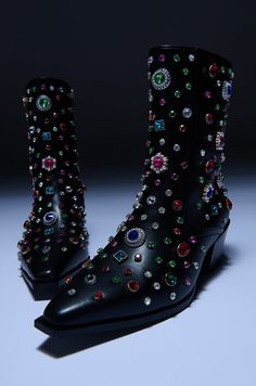 Add a dash of sparkle to your ensemble with The AZALEA WANG Sprinkles Embellished Bootie in Black. This finely decorated boot features a faux leather upper, an intricate assortment of rhinestone gemstone detailing, silver metallic hardware, Western-inspired tonal embroidered panels, and an ankle height shaft. Complete with a pointed toe silhouette, an extended rubber sole, a tonal inner ankle zipper closure, and a chunky stacked heel. Style with all black outfits for a flash of subtle color. (all measurements are approximate from size 7.5) - PVC Upper - Pointed Toe - Ankle Height Shaft - Chunky Stacked Heel - Rubber Outsole  - 2.25” Heel Height - 7” Shaft Height - 12.5” Shaft Opening Circumference - Imported Product ID: 382250 All Black Outfits, Azalea Wang, All Black Outfit, Whats New, Thigh High Boots, Stacked Heel, Thigh Highs, High Boots, Bootie