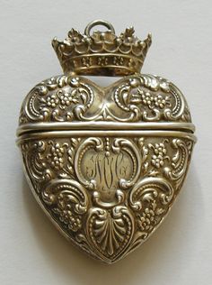 an ornate heart shaped locke with a crown on top