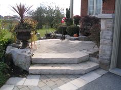 an outdoor patio with steps leading to the front door