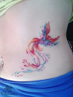 a woman's stomach with a bird tattoo on it