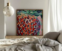 an abstract painting on the wall above a bed