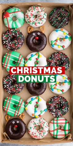 a box filled with christmas donuts covered in frosting and sprinkles