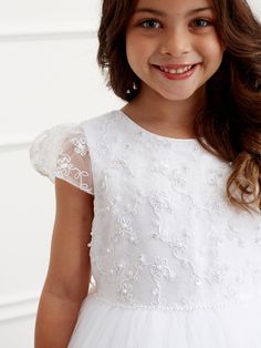 Gorgeous dress from Tip Top Kids will offer her the perfect chance to dial up the glamour and captivate the viewers. Lace tulle cape sleeve style with beaded lace appliques on the bodice, pearl waist and tulle skirt. Comes in white with rear center zipper and sash that bow ties at the back. Ivory Girls Dress, Tulle Cape, Holy Communion Dresses, Girls Ball Gown, Lace Bolero, Girls White Dress, First Communion Dress, Junior Bridesmaid Dress, Overlay Skirt