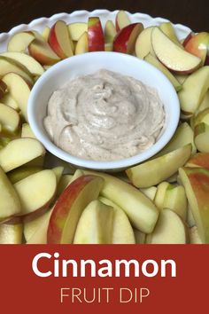 an apple and cinnamon fruit dip in a white bowl on a platter with sliced apples