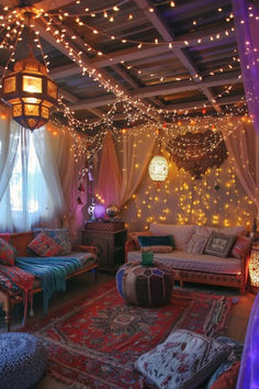 a living room filled with lots of furniture and lights hanging from the ceiling above it