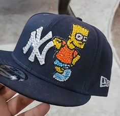 Custom made Simpson themed official NY new era snapback. With handcrafted shiny blinged out design. Custom New Era Hats, Diy Hats, Custom Fitted Hats, Dope Hats, New Era Snapback, New Era Hats, Diy Hat, Cute Hats, Custom Hats