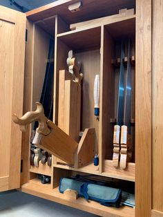 a wooden cabinet filled with lots of different types of woodworking tools in it's drawers