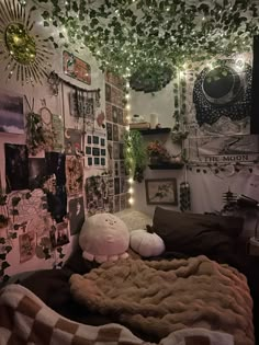 a bedroom with lots of pictures and lights on the wall above the bedspread