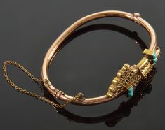 "Presented a fine gold Etruscan revival bypass hinged bracelet dated mid 1800's. It is hard to find such an antique bracelet in such excellent condition. The craftsmanship is astonishing. The band of the bracelet is made of rose gold. Fine filigree, cannetille face of the bracelet is coated with brushed yellow gold over rose gold. 4 sugar loaf cut Persian turquoise cabochons complete eye catching catching design. The bracelet is for size 6 1/2 with inner diameters 2 3/8\" and 1 3/4\". The face o Historical Yellow Gold Jewelry For Ceremonial Use, Historical Yellow Gold Jewelry For Ceremonial Occasions, Historical Yellow Gold Jewelry For Ceremonies, Historical Ceremonial Yellow Gold Jewelry, Historical Yellow Gold Jewelry For Wedding, Historical Gold Jewelry For Weddings, Historical Yellow Gold Wedding Jewelry, Persian Turquoise, Antique Bracelets