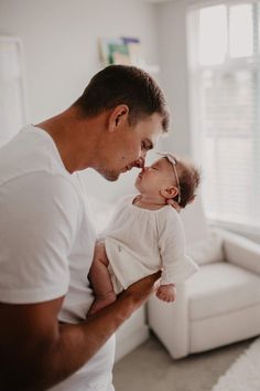 a man holding a baby in his arms