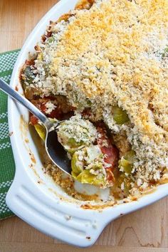 a casserole dish filled with vegetables and topped with crumbled toppings