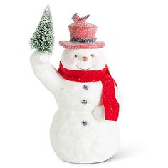 a snowman with a red scarf and hat holding a small christmas tree in his hand