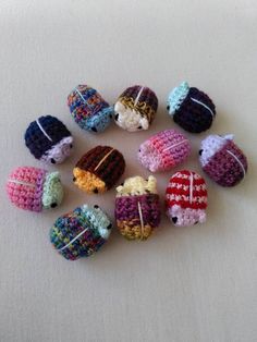 small crocheted ornaments are arranged on a white surface