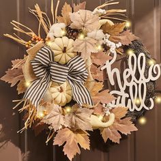 a wreath that says hello fall with pumpkins and leaves