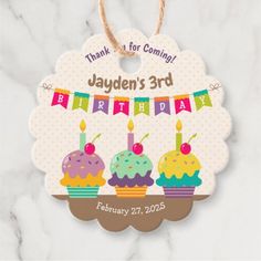 a personalized birthday ornament with three cupcakes