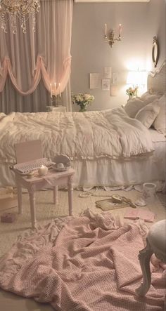 a bed room with a neatly made bed and chandelier