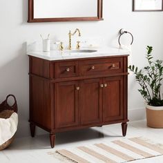 a bathroom with a sink, mirror and rug