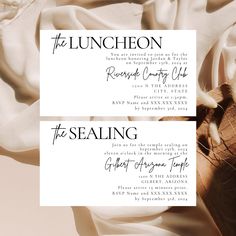 two white cards with black ink on them and the words, the luncheon, are laying next to each other