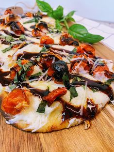 a pizza sitting on top of a wooden cutting board