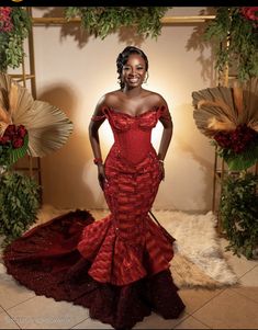 a woman in a red dress posing for the camera