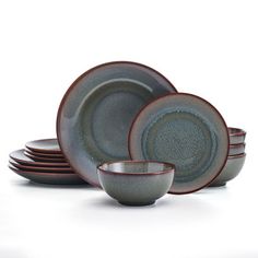 a set of gray and red dinnerware on a white background with no one in it