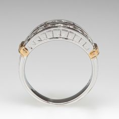 This classy white gold ring features eighteen (18) round brilliant cut diamonds, channel set into two (2) rows. The shoulders are each accented with a yellow gold, engraved bar. The ring measures 7.4mm at the top, rises 4.2mm above the finger, tapering to 3.7mm wide and 1.1mm thick at the base of the shank. This ring is currently a size 6.5. Timeless Diamond Ring With Channel Set For Anniversary, Timeless Channel Set Diamond Ring For Anniversary, Luxury Diamond Ring With Channel Set For Anniversary, Luxury Channel Set Diamond Ring For Anniversary, Luxury Anniversary Ring With Channel Set, Luxury Channel Set Rings For Anniversary, Luxury Channel Set Anniversary Rings, Diamond Anniversary Rings, Diamond Anniversary