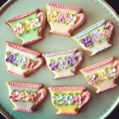 decorated cookies in the shape of tea cups and flowers