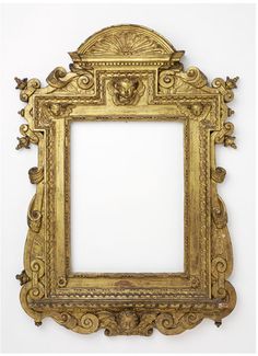 an ornate gold frame on a white wall