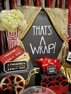 an assortment of movie themed items including popcorn buckets, film reels and clapperboard signs