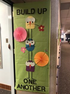 a bulletin board with paper cutouts on the front and back of it that says build up one another