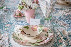 the table is set with dishes, cups and saucers