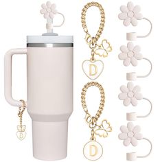 a white coffee mug with two chain bracelets attached to it and the words d on each side