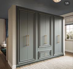 an image of a room that is painted in blue and grey colors with gold handles