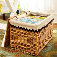 a wicker basket sitting on the floor in front of a window