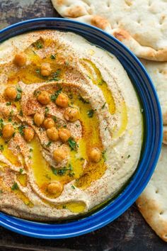 hummus and pita bread on a blue plate