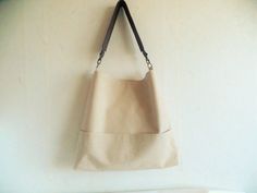 Linen bag, medium bucket bag, hobo slouchy bag purse, everyday casual shoulder bag in beautiful natural linen oatmeal light beige color with real leather strap in dark chocolate brown. * Exterior - Natural linen in beautiful shade of light beige color - Two outside exterior pockets *Interior - Cotton lining - Two inside interior pockets * Closes with magnetic snap button * Real leather strap from high quality italian genuine leather in gorgeous dark chocolate brown color. Reinforced with antique Crossbody Canvas Shopping Bag With Pockets, Everyday Bucket Bag With Double Handle And Pockets, Simple Beige Satchel Shoulder Bag, Shopping Crossbody Shoulder Bag With Pockets, Crossbody Shoulder Bag With Pockets For Shopping, Canvas Bucket Bag With Pockets For Shopping, Shopping Tote Shoulder Bag With Pockets, Chic Canvas Bag With Pockets For Everyday, Chic Everyday Canvas Bag With Pockets