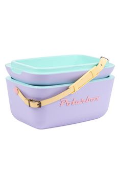 two purple and blue containers with gold handles on the sides, one has a yellow handle