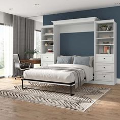 a bedroom with a bed, desk and bookcases in the middle of it