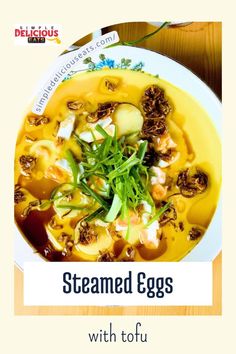 steamed eggs with tofu and vegetables in a yellow bowl on top of a wooden table